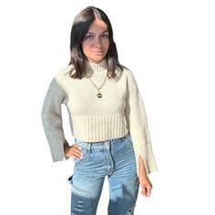 Embrace a playful yet chic look with our Cropped Bell Sleeve Sweater. Its cropped cut and bell sleeves make it perfect for pairing with high-waisted jeans or skirts. Ideal for adding a trendy touch to your wardrobe. Shop more Sweaters Model is wearing a small Shop more colors Cream Cropped Fuzzy texture Ribbed knit Sleeve slits Mock neck Thick rib knit trim 73% acrylic, 14% nylon, 10% wool, 3% spandex Still not sure which size to get? Ask one of our stylists! Please give us a call at 856-452-582 Trendy Fall Cropped Sweater, Fall Cropped Sweater Top, Trendy Winter Crop Top, Chic Long Sleeve Cropped Sweater, White Cropped Crop Top For Fall, Casual High Waist Crop Top For Fall, Fitted High Waist Crop Top For Fall, Trendy Cropped Sweater For Fall, Trendy Knit Cropped Sweater