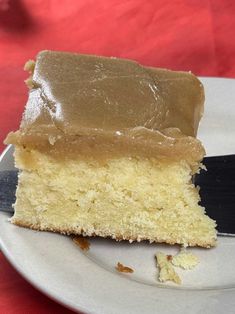 a piece of cake sitting on top of a white plate with a knife next to it