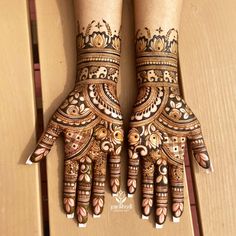 two hands with henna designs on them