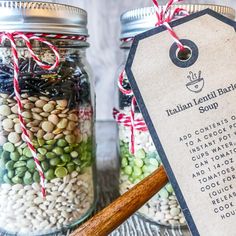 two jars filled with different types of beans and other things to put in them on the table