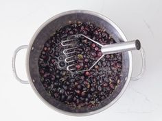 a metal bowl filled with berries and a whisk