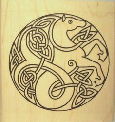 a wooden stamp with an image of a fish and celtic designs on it's side