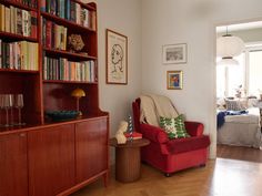 a living room filled with furniture and bookshelves