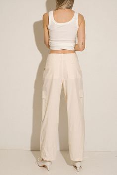 Loosely tailored cargo pant in a soft yet structured cotton. Straight leg with tie at ankle, cinch for a more tapered silhouette. Side pockets and oversized patch pockets above knee. Made in New York City. Fabric is 100% cotton. Ella is 6' tall, 35" bust, 26" waist, 36" hip, and is wearing a size S. City Fabric, How To Hem Pants, Cargo Pant, Bottom Clothes, Above Knee, Sale Design, Patch Pocket, Casual Pants, New York City