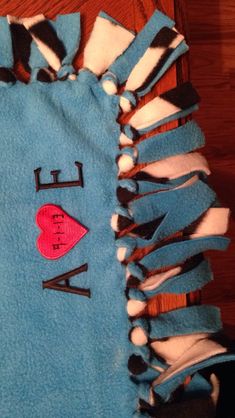 a blue towel with the words i love you written on it and a red heart