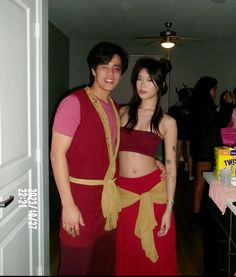 a man and woman in costume standing next to each other