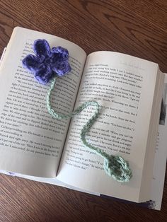 an open book with crocheted flowers on it