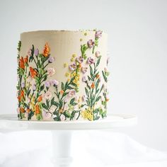 a white cake with flowers painted on it