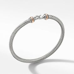 David Yurman's artistic signature, Cable began as a bracelet that he hand-twisted from 50 feet of wire. For the past 30 years, he has evolved the twisted helix into a myriad of designs. Sterling Silver with 18-karat Rose Gold Bracelet, 4mm Hook clasp Size Medium: Fits a wrist measuring 6-6.5 inches in circumference Style Number: B11295 SRM Cable Bracelets, Buckle Bracelet, Metal Shop, Rose Gold Bracelet, Hook Clasp, David Yurman, Jewelry Pouch, Helix, Bracelet Designs