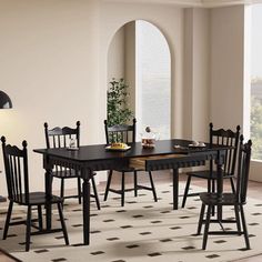 a dining room table and chairs with a rug on the floor in front of it