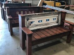 an old wooden bench with the word ford painted on it's back and side