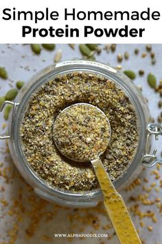 a jar full of homemade protein powder with a spoon in it and text overlay