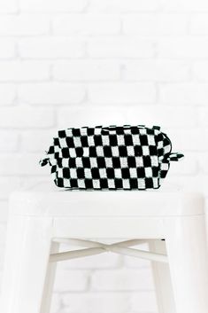 The Sweetest Thing Pouch is perfect for storing your makeup, pens/pencils, or even for keeping in the car to hold all your on-the-go essentials! Whatever it is, we know you'll get lots of use out of this multi use pouch. Featuring a checkered print knit material with inner lining and a zip closure. Lined + Zipper closure 11" x 4.5" x 3" Keywords: Pouch, Makeup Bag, Checker Print Black Rectangular Pouch Gift Case, Black Rectangular Pouch For Gifts, Black Rectangular Pencil Case With Zipper, Black Rectangular Pouch As Gift, Rectangular Black Pouch For Gift, Black Rectangular Zipper Pencil Case, Black Zipper Pencil Case For Personal Use, Rectangular Black Cosmetic Bag Gift, Black Pouch With Pen Holders For School