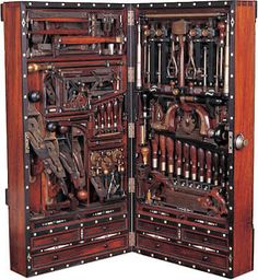 an open wooden cabinet with many different tools in the front and side doors on each side