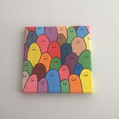 a colorful painting on a white wall with lots of little people