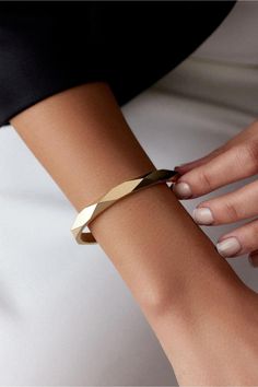 14K Handcuff Gold Geometric Bracelet | Modern Design Statement Cuff Bangle for Women | Plain Gold Hinged Bracelet | Geometric Cuff Bracelet | Perfect Gift for Her ☑ Material: 14K Gold, Real gold ☑ Weight: 11.70 grams ☑ Purity: 14 Karat ☑ Color: Yellow Gold ☑ Width of the Bangle: 5 mm ☑ Stones: None Product Features: This exquisite bracelet is crafted from high-quality 14K gold, offering both durability and elegance. It features a unique prism-shaped geometric design that makes it a standout statement piece. The bracelet's sleek, modern design is perfect for any occasion, whether you're dressing up or down. The hinged clasp ensures a secure and comfortable fit. Care Instructions | To keep your bracelet in pristine condition: - Avoid contact with chemicals such as perfume, alcohol, and cream Modern Gold Open Cuff Jewelry, Gold Open Cuff Bracelets For Party, Elegant Metal Open Cuff Bracelets, Modern Party Cuff Bangle Bracelet, Elegant Open Cuff Metal Bracelet, Polished Finish Bangle For Parties, Modern Twist Cuff Bracelet Bangle For Formal Occasions, Modern Twist Bangle Cuff Bracelet For Formal Occasions, Modern Bangle With Bracelet Strap Jewelry