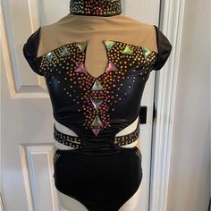 a woman's bodysuit with multicolored sequins on the back