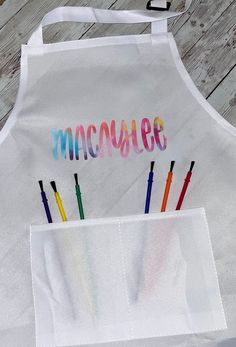 an apron that has some crayons in it