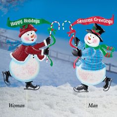 two snowmen with hats and scarfs holding candy canes on top of each other