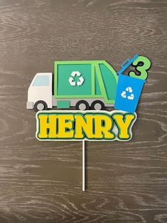 there is a sign that says henry with a garbage truck and recycle on it