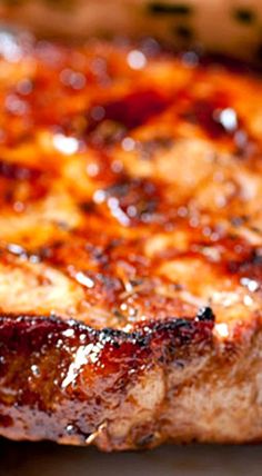 a piece of meat sitting on top of a pan covered in ketchup and mustard