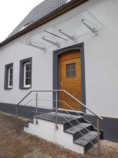 an entrance to a building with steps leading up to it and a wooden door on the side