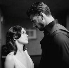 black and white photograph of man and woman looking at each other's eyes together