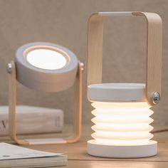 a white light sitting on top of a wooden table next to a pile of books