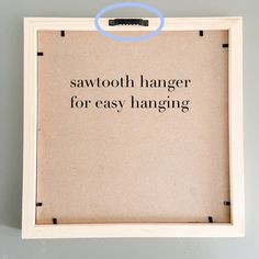 a sign that says, sawtooth hanger for easy hanging on the wall above it