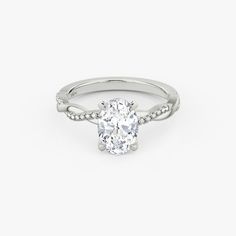 an oval cut diamond ring with pave set shoulders