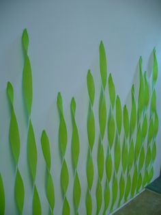 the wall is painted with green leaves on it