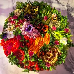 a bunch of different types of flowers arranged in a circular arrangement on a marble surface