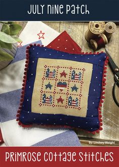 an embroidered pillow with the words, july nine patch in red, white and blue