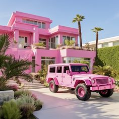 a pink jeep is parked in front of a large house with palm trees and bushes