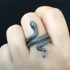 These gothic-inspired Snake ring is sure to make a statement with intricate texture and sparkling cubic zirconia eye. Wrap them around your fingers for a bold and eye-catching look. Material : 316 Stainless steel Finish: Silver with heavy oxidation and Black Size: 35mm long Eyes are set with Black CZ stones Ships in a gift box Snake Rings, Serpent Ring, Oxidized Ring, Gothic Ring, Writing Motivation, Snake Jewelry, Gothic Rings, Black Snake, Snake Ring