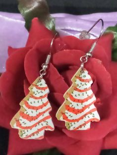 1.9 inches long x 0.7 inches wide Cute Little Debbie Christmas Tree Snack Cake Acrylic Dangle Earrings are your PERFECT Festive Jewelry this Season.  Made of Acrylic so they are super lightweight with plenty of eye catching dangle.  Stainless Steel Fish Hook Pierced earrings are Super Trendy and Stylish.  Grab yours now before they Sell Out! Little Debbie Christmas Tree, Cake Earrings, Little Debbie, Tree Cake, Christmas Tree Cake, Tree Cakes, Earrings Christmas, Snack Cake, Holiday Jewelry