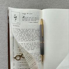 an open notebook with a pen and paper on it