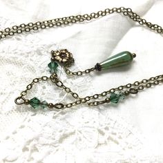 Elegant Green Dangle Drop Necklace, Elegant Adjustable Green Lariat Necklace, Adjustable Teardrop Brass Necklace, Bohemian Green Jewelry With Vintage Charm, Green Bohemian Jewelry With Vintage Charm, Green Dangle Drop Necklace As Gift, Green Teardrop Necklace With Adjustable Chain, Vintage Drop Necklace For Gift, Green Teardrop Pendant With Adjustable Chain