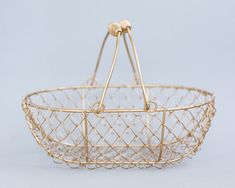 a gold wire basket with two handles