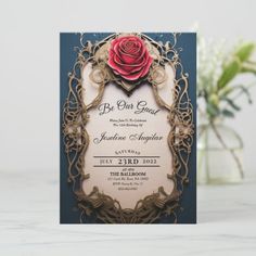 a wedding card with a red rose on the front, and an ornate frame around it