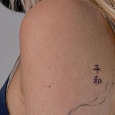 a woman with a tattoo on her shoulder