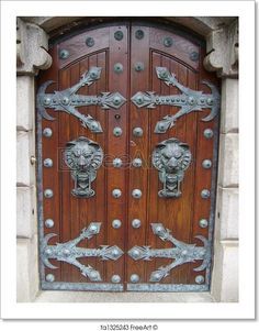 an ornate wooden door with metal decorations on it