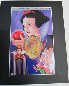 snow white and the seven dwarfs movie poster framed in black wood frame with matte paper