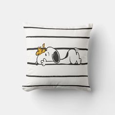 a pillow with a cartoon dog laying on it's side and wearing a crown