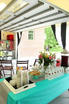 a blue table topped with lots of bottles and glasses