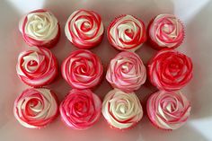 cupcakes with white and red frosting in a square shape on a table