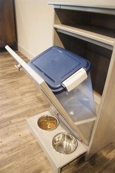 an elevated dog food station with two bowls in it