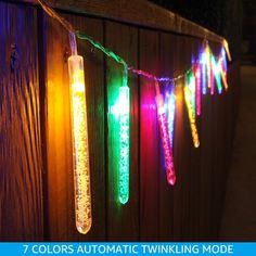 colorful lights are hanging on a fence outside in the dark with text overlay that reads 7 colors automatic twinkling mode