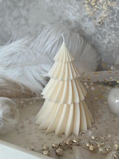 a white christmas tree sitting on top of a table