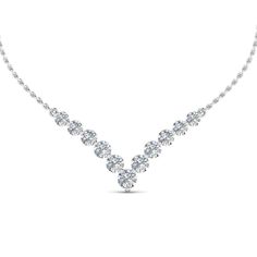 This 0.70 Carat Round Diamond Graduated V Necklace excellently features brilliant round cut diamonds with flawless shine arranged marvelously in a classic shared prong setting forming a graduated V-shaped pattern held through a glossy metallic chain for added opulence and panache.  Round cut diamonds of 0.70 Total Carat Weight with Clarity SI2 and Color G in a prong setting. Total Number of Diamonds:- 11 This diamond necklace can also be acquired in a variation of precious metals of your preference. Free Shipping Within USA. 1 Year Manufacturing Warranty. 30 Days Returns With Lifetime Upgrade. Buy now and pay later with our Easy financing plan. If you don’t find your desired jewelry, please don’t hesitate to contact our in-house designer to make your desired jewelry design The Bling Ring, Diamond Earrings Studs Round, Anniversary Necklace, Graduation Necklace, Round Diamond Setting, Jewelry Appraisal, Diamond Anniversary, White Gold Jewelry, Best Diamond